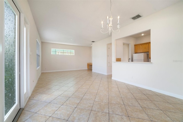 7740 Linkside Loop, Reunion, FL 34747 - unfurnished room with a chandelier, light tile patterned flooring, and baseboards