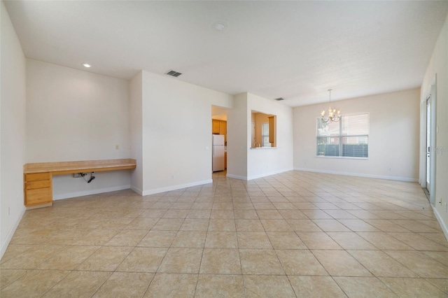 7740 Linkside Loop, Reunion, FL 34747 - empty room with a chandelier, light tile patterned floors, and baseboards