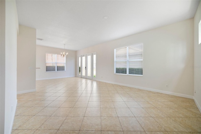 7740 Linkside Loop, Reunion, FL 34747 - spare room featuring a chandelier, light tile patterned flooring, baseboards, and french doors