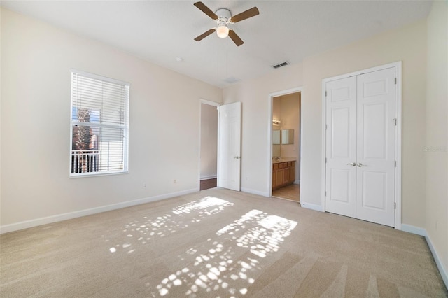 7740 Linkside Loop, Reunion, FL 34747 - unfurnished bedroom with light carpet, baseboards, and ensuite bath