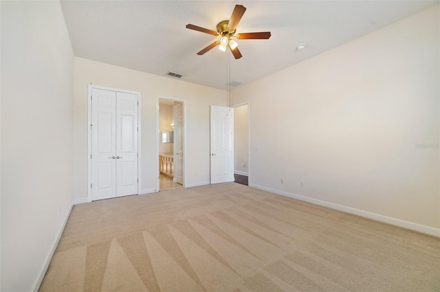 7740 Linkside Loop, Reunion, FL 34747 - unfurnished bedroom with carpet floors, baseboards, connected bathroom, and a ceiling fan