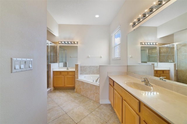 7740 Linkside Loop, Reunion, FL 34747 - bathroom featuring a shower stall, two vanities, tile patterned floors, and a garden tub