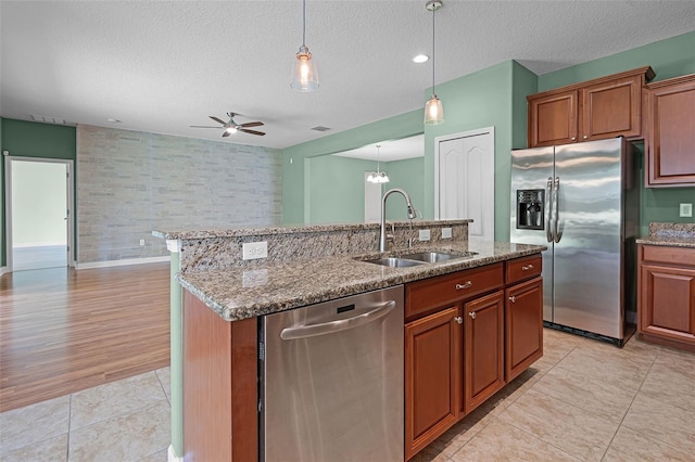 1394 Palmetto Dunes St, Champions Gate, FL 33896 - kitchen with appliances with stainless steel finishes, a sink, ceiling fan, a kitchen island with sink, and a textured ceiling