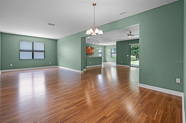1394 Palmetto Dunes St, Champions Gate, FL 33896 - unfurnished living room with dark wood-style flooring, ceiling fan, a chandelier, and baseboards