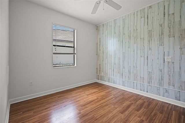 1394 Palmetto Dunes St, Champions Gate, FL 33896 - empty room with wood finished floors, ceiling fan, and baseboards