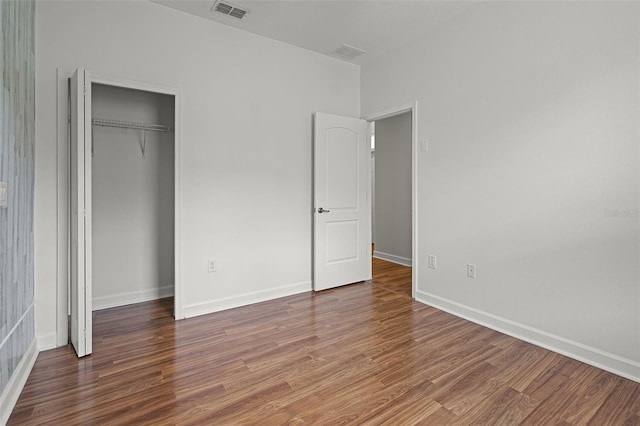 1394 Palmetto Dunes St, Champions Gate, FL 33896 - unfurnished bedroom featuring wood finished floors, baseboards, and a closet