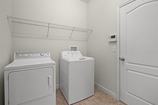 1394 Palmetto Dunes St, Champions Gate, FL 33896 - laundry room with washer and clothes dryer, light tile patterned flooring, and baseboards