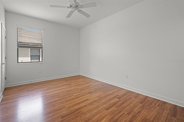 1394 Palmetto Dunes St, Champions Gate, FL 33896 - spare room featuring wood finished floors, a ceiling fan, baseboards, and a textured ceiling