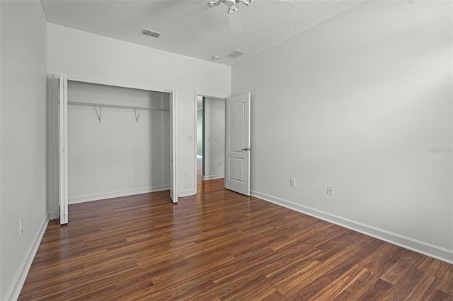 1394 Palmetto Dunes St, Champions Gate, FL 33896 - unfurnished bedroom with wood finished floors, a closet, baseboards, and a textured ceiling