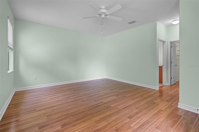 1394 Palmetto Dunes St, Champions Gate, FL 33896 - unfurnished room with ceiling fan, wood finished floors, and baseboards