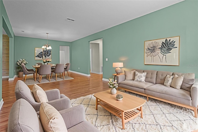 1394 Palmetto Dunes St, Champions Gate, FL 33896 - living room with a chandelier, wood finished floors, and baseboards