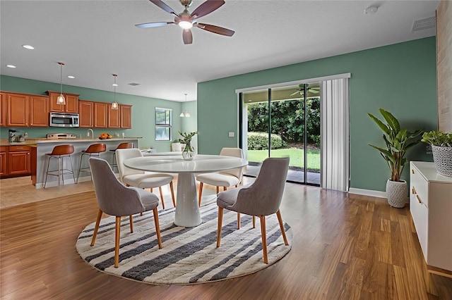 1394 Palmetto Dunes St, Champions Gate, FL 33896 - dining space featuring a ceiling fan, recessed lighting, light wood-style floors, and baseboards