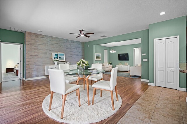1394 Palmetto Dunes St, Champions Gate, FL 33896 - dining space featuring a ceiling fan, an accent wall, wood finished floors, and baseboards