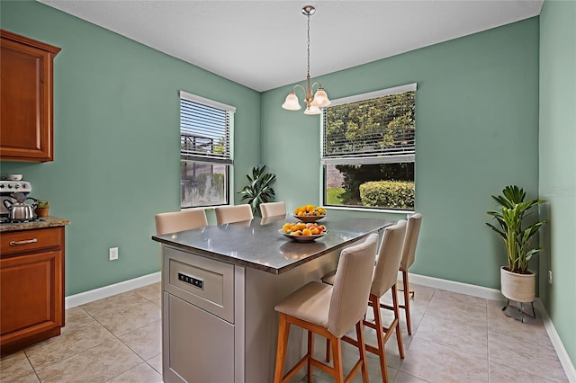1394 Palmetto Dunes St, Champions Gate, FL 33896 - dining space with a chandelier, light tile patterned flooring, and baseboards
