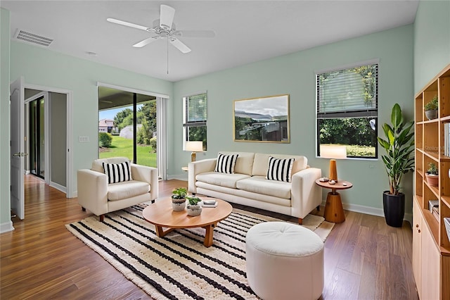 1394 Palmetto Dunes St, Champions Gate, FL 33896 - living area featuring wood finished floors, baseboards, and a ceiling fan