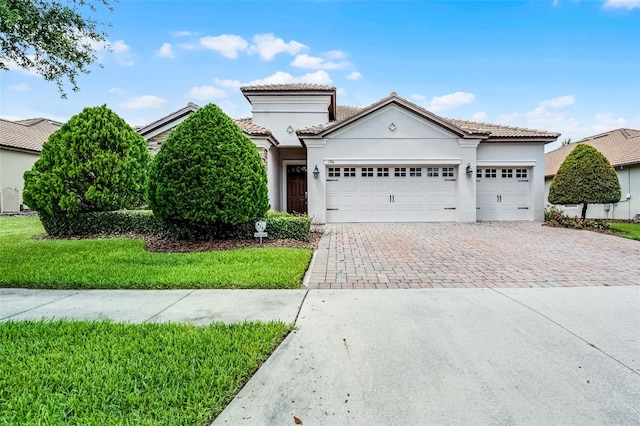 1394 Palmetto Dunes St, Champions Gate, FL 33896 - mediterranean / spanish-style house with driveway, a garage, a tiled roof, and stucco siding