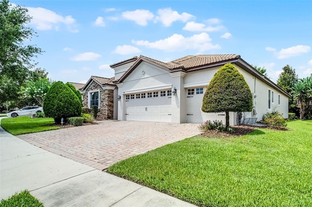 1394 Palmetto Dunes St, Champions Gate, FL 33896 - view of front facade featuring stucco siding, a garage, decorative driveway, a tile roof, and a front yard