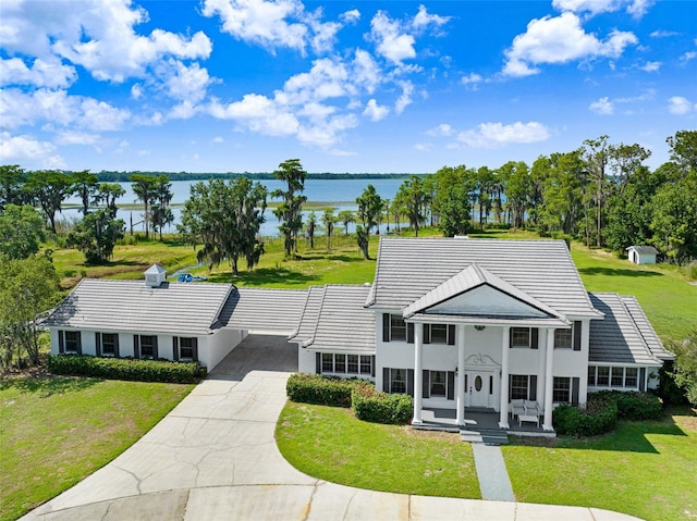5150 Gentry Oaks Pl, Saint Cloud, FL 34772 - view of front of home with a water view, driveway, a carport, a front yard, and a tiled roof