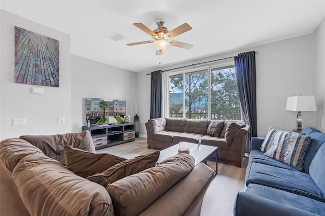 5038 Tideview Cir Unit 21, Orlando, FL 32819 - living area featuring a ceiling fan and light wood-style flooring