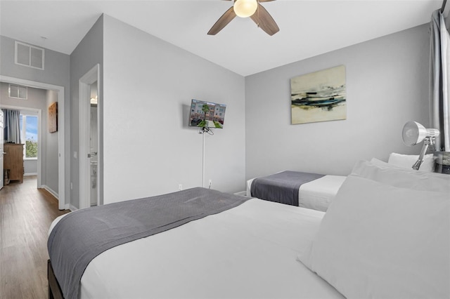 5038 Tideview Cir Unit 21, Orlando, FL 32819 - bedroom featuring wood finished floors, ceiling fan, and baseboards