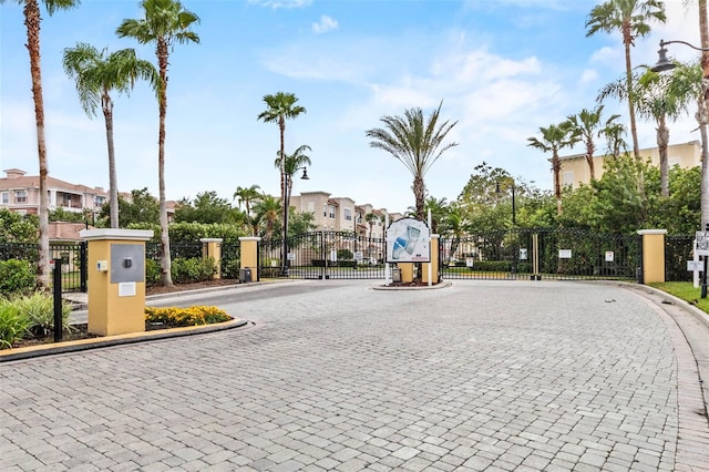 5038 Tideview Cir Unit 21, Orlando, FL 32819 - view of road with a gate, curbs, and a gated entry
