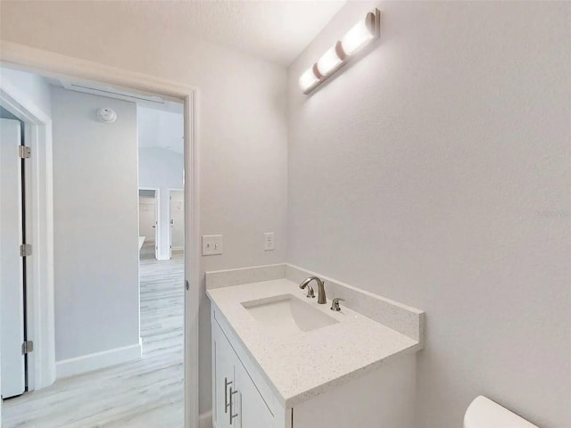 14512 SW 25th Ln, Ocala, FL 34481 - half bathroom featuring vanity, wood finished floors, toilet, and baseboards