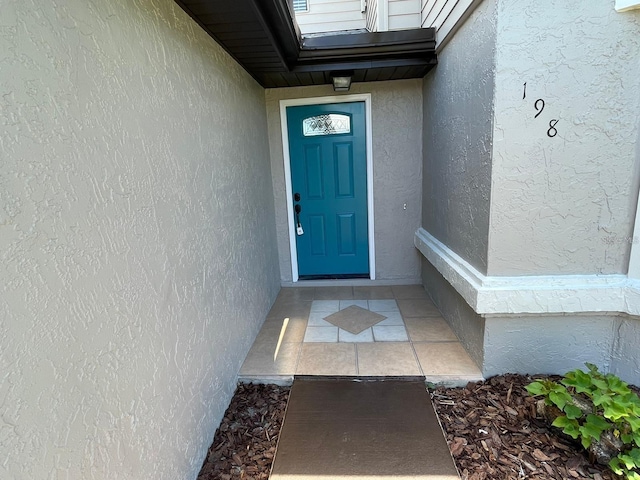 198 N Lake Ct, Kissimmee, FL 34743 - doorway to property with stucco siding