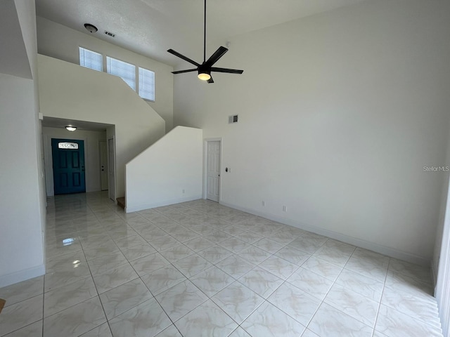 198 N Lake Ct, Kissimmee, FL 34743 - unfurnished living room featuring a high ceiling, ceiling fan, and baseboards