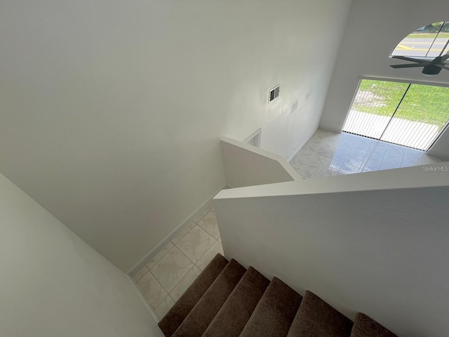 198 N Lake Ct, Kissimmee, FL 34743 - staircase featuring a ceiling fan, baseboards, and tile patterned floors