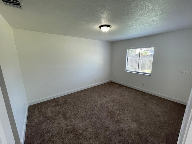 198 N Lake Ct, Kissimmee, FL 34743 - unfurnished room featuring dark carpet, baseboards, and a textured ceiling