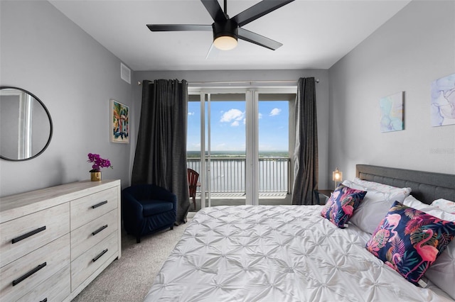 13427 Blue Heron Beach Dr Unit 1703, Orlando, FL 32821 - bedroom featuring light carpet, access to exterior, a water view, and ceiling fan