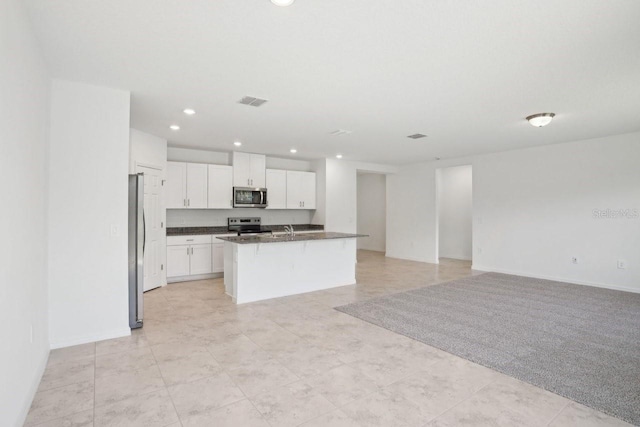 3214 Viceroy Ct, Kissimmee, FL 34759 - kitchen with stainless steel appliances, open floor plan, dark countertops, recessed lighting, and white cabinets
