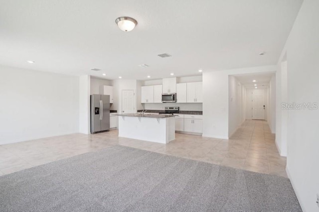 3214 Viceroy Ct, Kissimmee, FL 34759 - kitchen with stainless steel appliances, open floor plan, white cabinets, light tile patterned floors, and recessed lighting