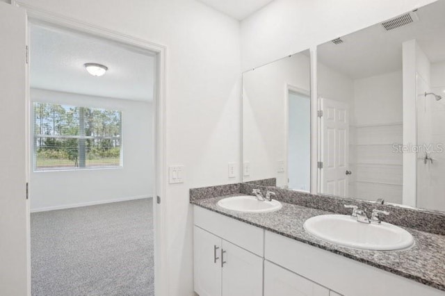 3214 Viceroy Ct, Kissimmee, FL 34759 - bathroom with double vanity and baseboards