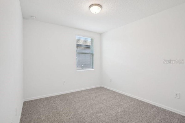 3214 Viceroy Ct, Kissimmee, FL 34759 - carpeted spare room with baseboards and a textured ceiling
