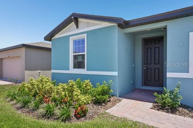 3214 Viceroy Ct, Kissimmee, FL 34759 - property entrance with stucco siding and a garage