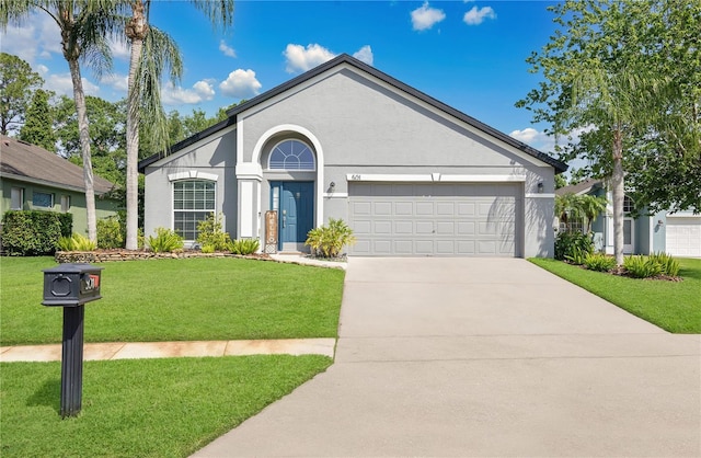 501 Dunoon St, Ocoee, FL 34761 - ranch-style home featuring a garage, a front lawn, concrete driveway, and stucco siding
