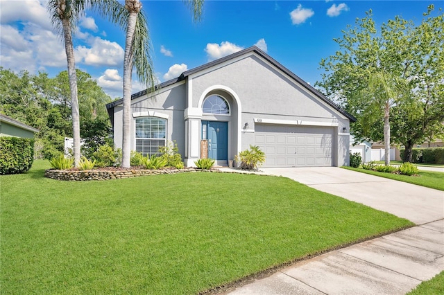 501 Dunoon St, Ocoee, FL 34761 - ranch-style house featuring an attached garage, driveway, a front yard, and stucco siding
