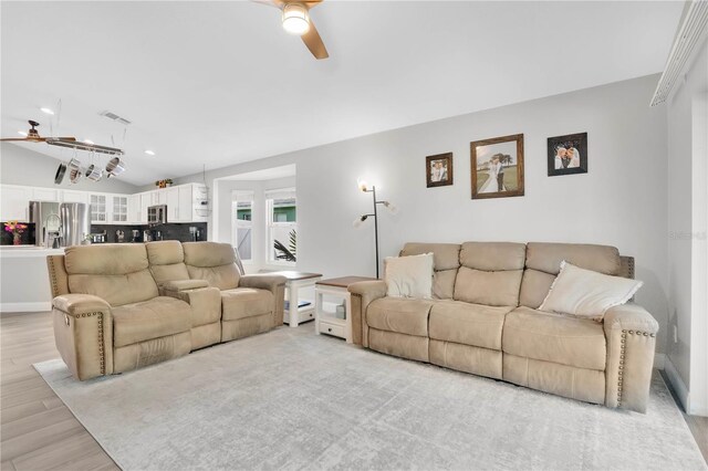 501 Dunoon St, Ocoee, FL 34761 - living room with a ceiling fan, vaulted ceiling, and light wood-style floors