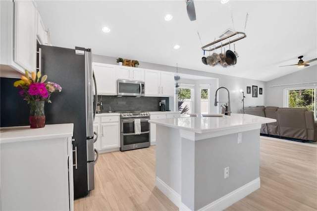 501 Dunoon St, Ocoee, FL 34761 - kitchen with appliances with stainless steel finishes, ceiling fan, a sink, light wood-type flooring, and recessed lighting