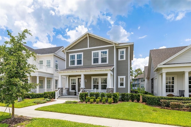 2057 Celebration Blvd, Kissimmee, FL 34747 - craftsman house featuring a porch and a front lawn