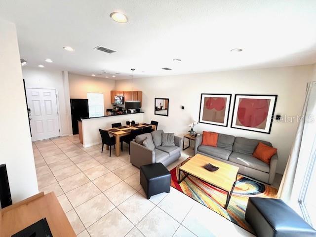 3014 Red Ginger Rd, Kissimmee, FL 34747 - living room featuring light tile patterned floors and recessed lighting