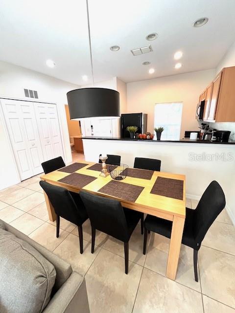 3014 Red Ginger Rd, Kissimmee, FL 34747 - dining space featuring light tile patterned flooring and recessed lighting