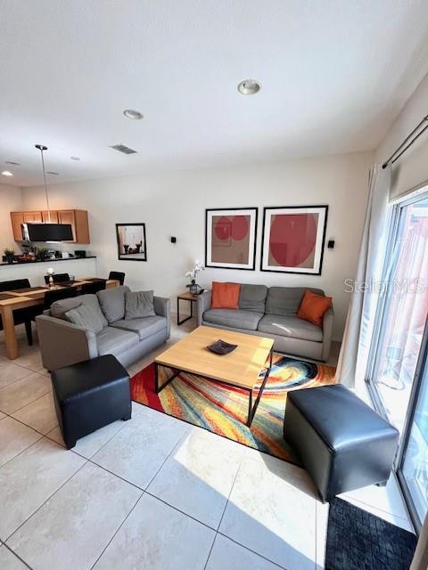 3014 Red Ginger Rd, Kissimmee, FL 34747 - living room featuring light tile patterned flooring and recessed lighting