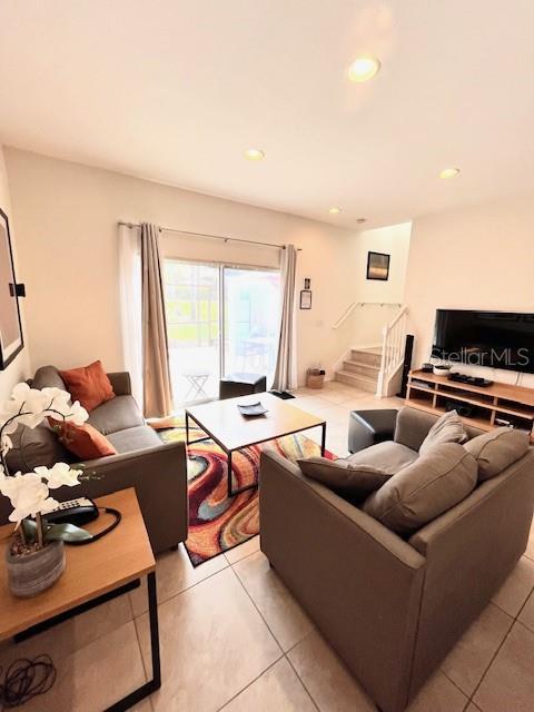 3014 Red Ginger Rd, Kissimmee, FL 34747 - living area featuring light tile patterned floors, stairs, and recessed lighting
