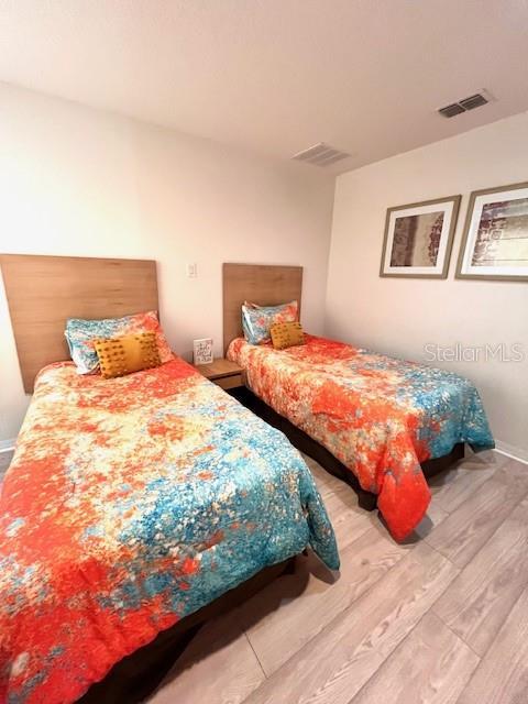 3014 Red Ginger Rd, Kissimmee, FL 34747 - bedroom featuring light wood-type flooring and baseboards