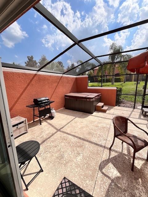 3014 Red Ginger Rd, Kissimmee, FL 34747 - view of patio / terrace with a hot tub, a lanai, and grilling area
