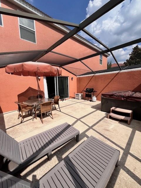 3014 Red Ginger Rd, Kissimmee, FL 34747 - view of patio / terrace featuring a hot tub, outdoor dining area, and a lanai