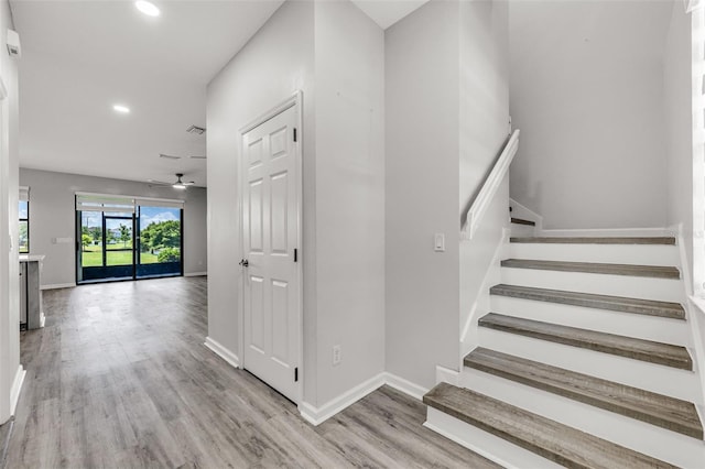 1628 Portofino Meadows Blvd, Orlando, FL 32824 - staircase with recessed lighting, wood finished floors, ceiling fan, and baseboards