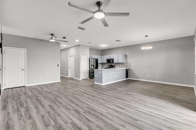 1628 Portofino Meadows Blvd, Orlando, FL 32824 - unfurnished living room featuring a ceiling fan, baseboards, light wood-style floors, and recessed lighting